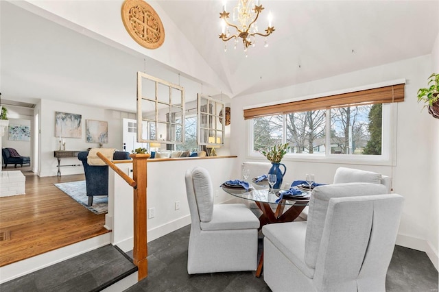 dining space featuring lofted ceiling, dark hardwood / wood-style floors, and a chandelier