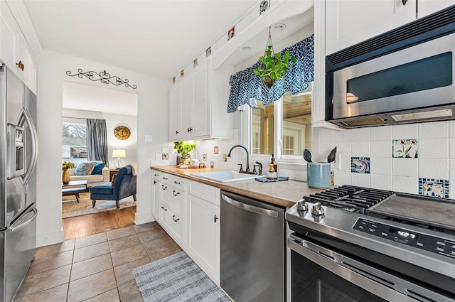 kitchen featuring white cabinetry, appliances with stainless steel finishes, and sink