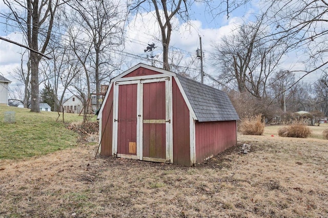 view of outbuilding with a yard