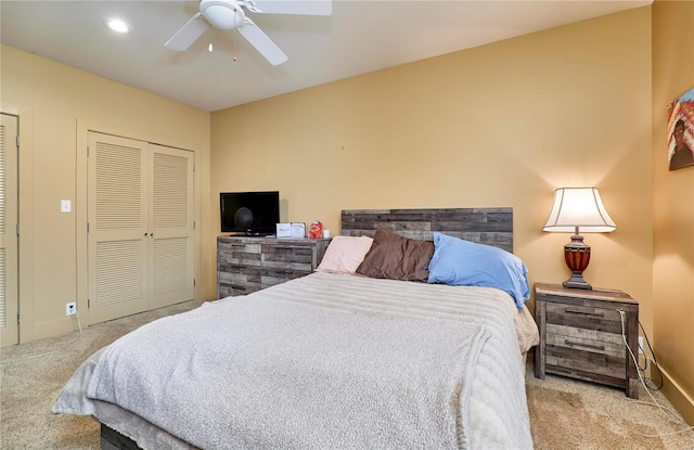 bedroom featuring ceiling fan, light colored carpet, and a closet