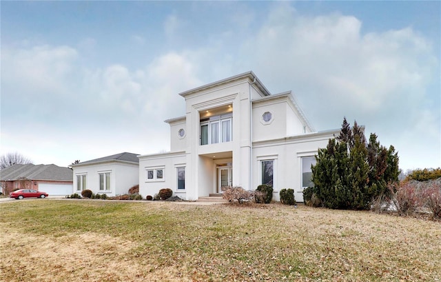 view of front facade with a garage and a front lawn