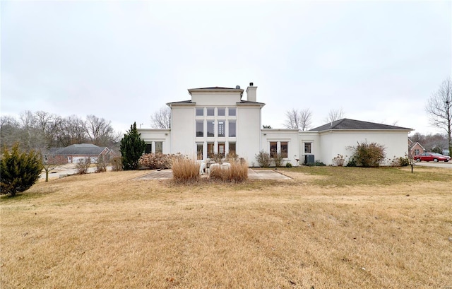 back of house featuring french doors and a lawn