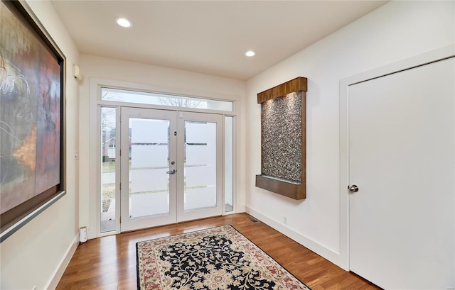 entrance foyer featuring dark hardwood / wood-style floors and french doors