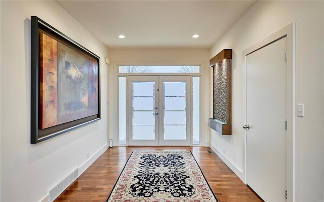 foyer featuring hardwood / wood-style flooring and french doors