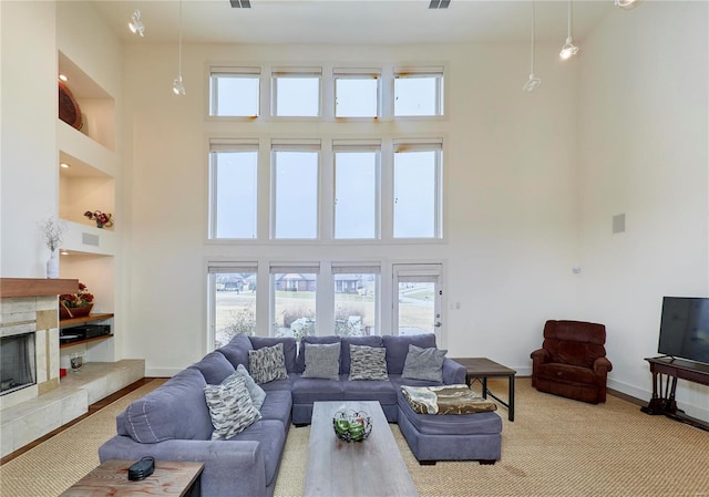 living room featuring a towering ceiling and a fireplace