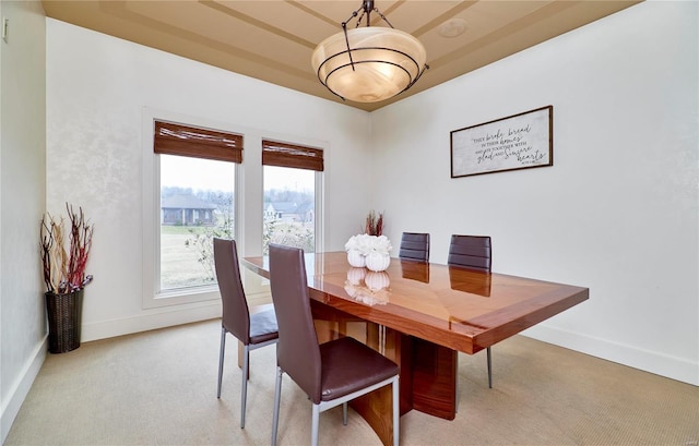 dining space featuring light carpet