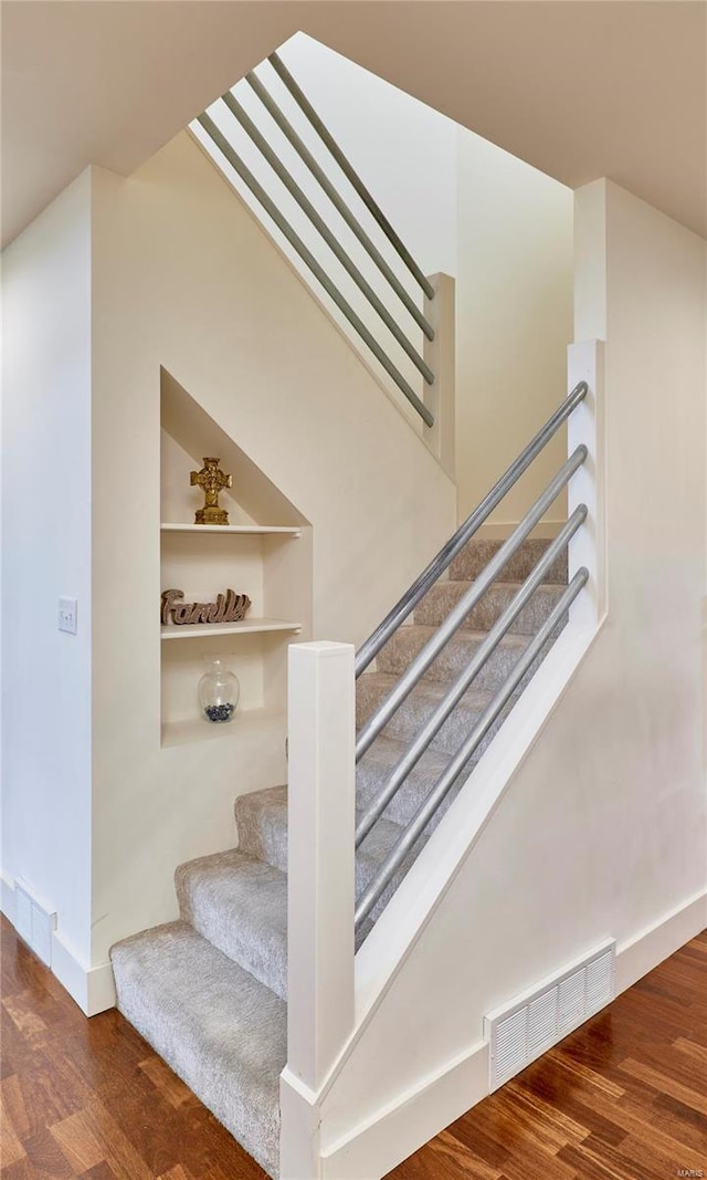 stairs featuring wood-type flooring