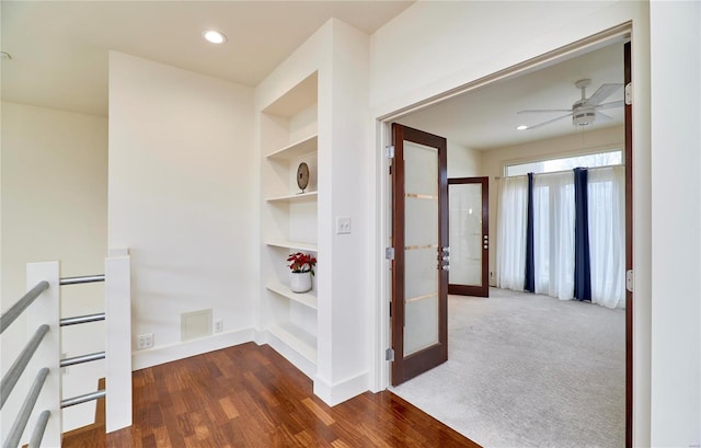 hall featuring dark hardwood / wood-style floors and built in features