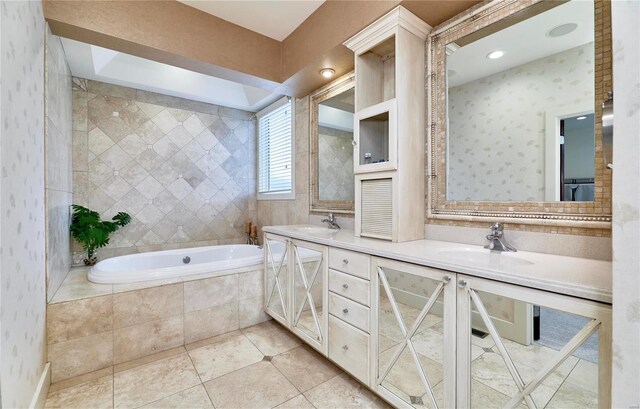 bathroom featuring vanity, tile patterned floors, and tiled bath