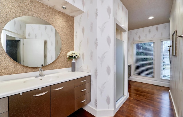 bathroom with vanity, wood-type flooring, and an enclosed shower