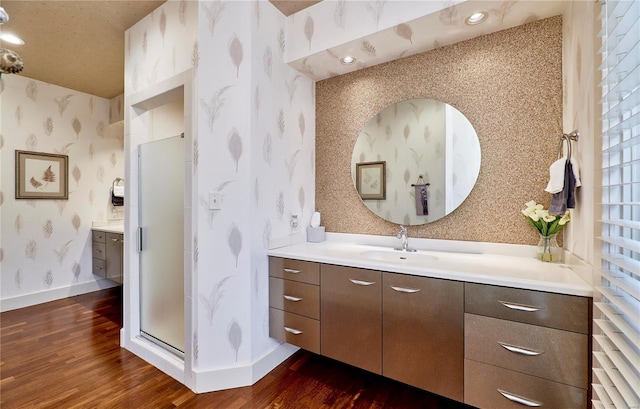 bathroom with vanity, an enclosed shower, and hardwood / wood-style floors