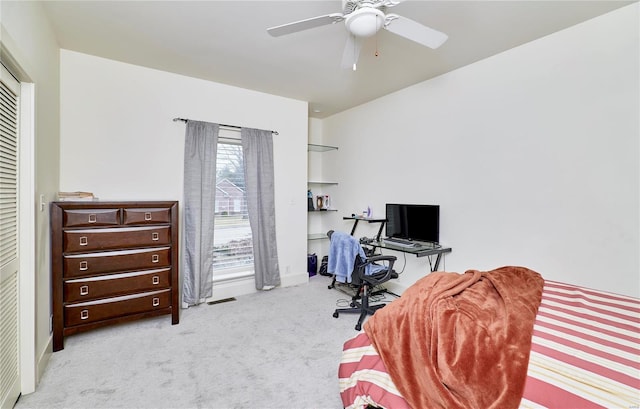 carpeted office with ceiling fan