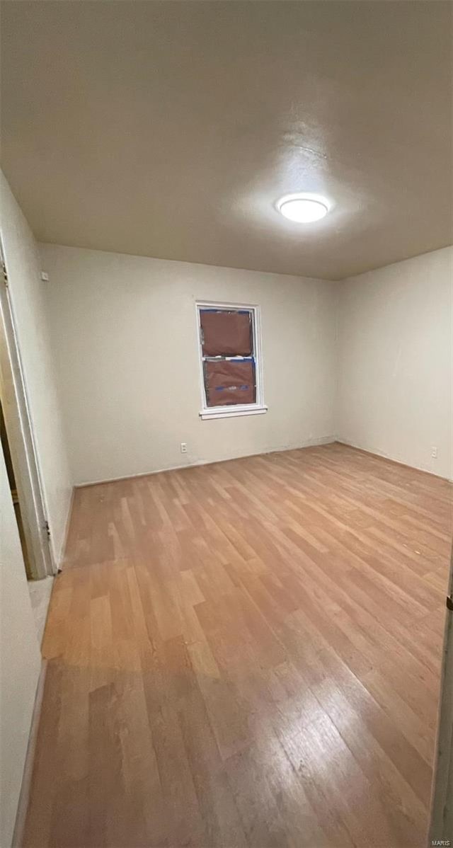 empty room with light hardwood / wood-style flooring