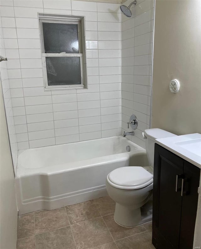 full bathroom with tile patterned floors, vanity, toilet, and tiled shower / bath