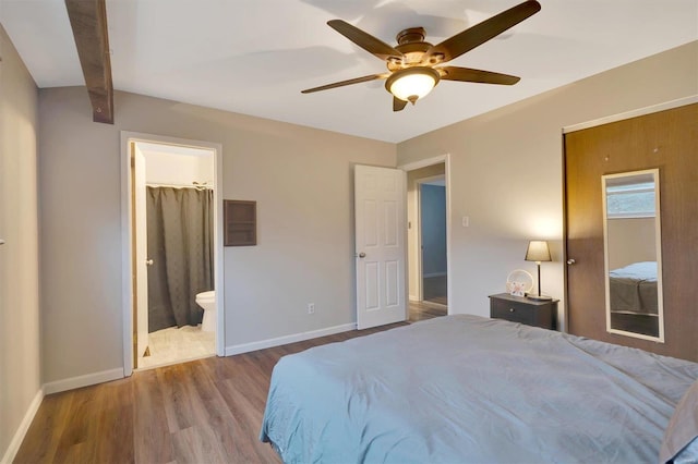 bedroom featuring ensuite bath, wood-type flooring, and ceiling fan