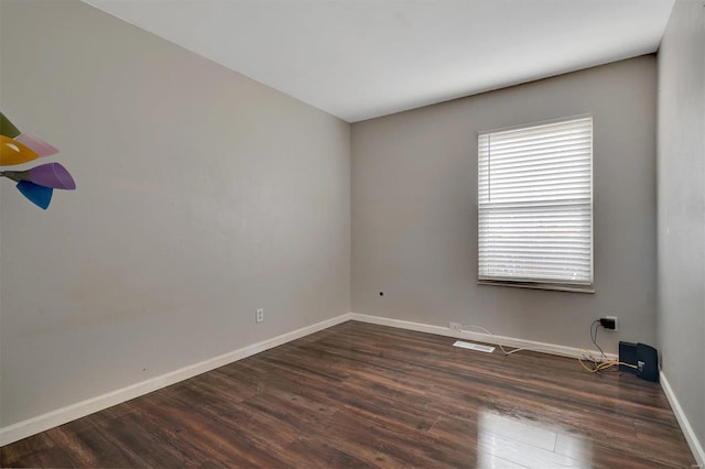 empty room with dark hardwood / wood-style floors