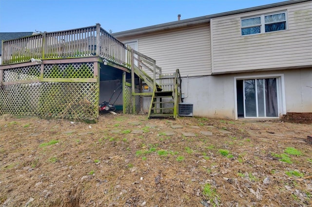 rear view of house with cooling unit and a deck