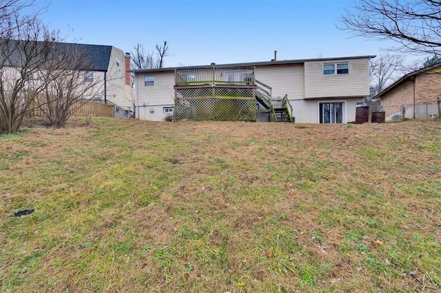 back of house with a wooden deck and a yard