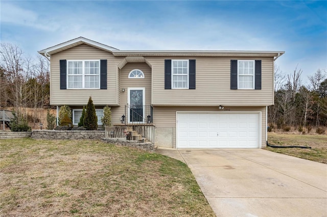 raised ranch with a garage and a front yard