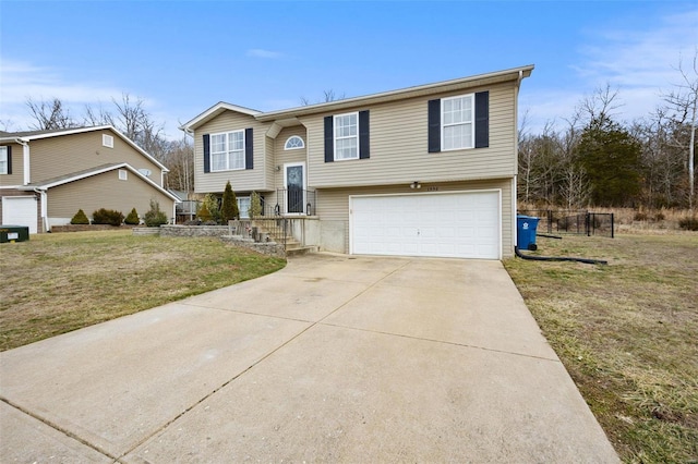 split foyer home featuring a garage and a front yard