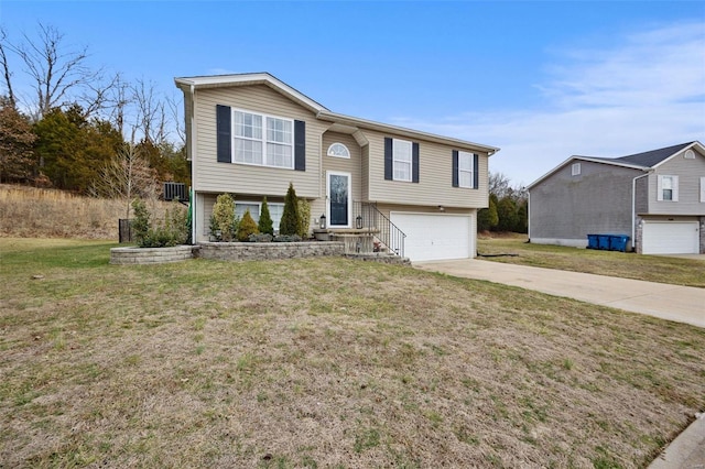 raised ranch with a garage and a front yard