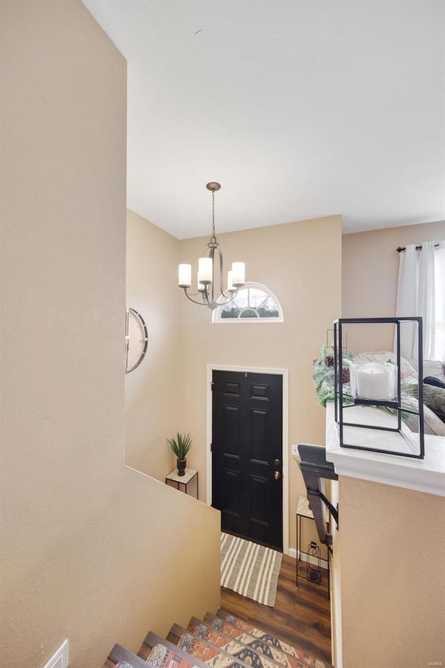 foyer entrance featuring a chandelier and dark hardwood / wood-style flooring