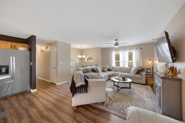 living room featuring dark hardwood / wood-style floors and ceiling fan with notable chandelier