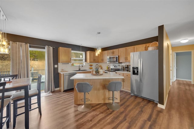 kitchen featuring pendant lighting, stainless steel appliances, dark hardwood / wood-style floors, and a kitchen island