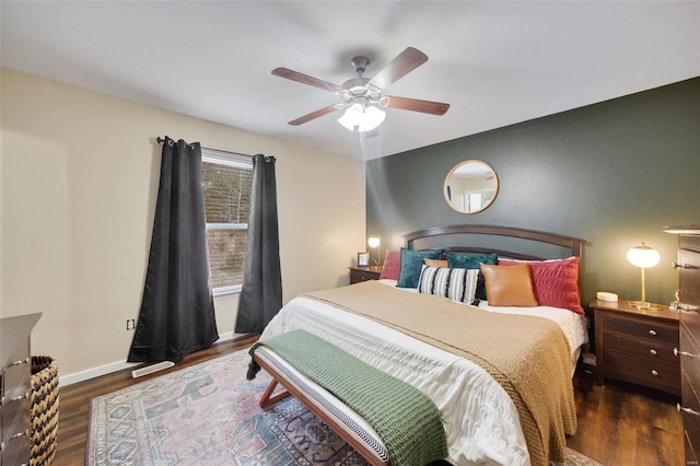 bedroom with ceiling fan and dark hardwood / wood-style flooring