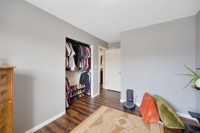 bedroom with dark hardwood / wood-style flooring