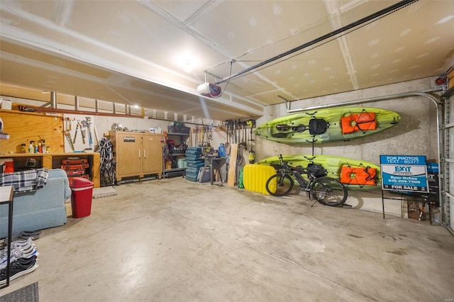 garage featuring a garage door opener and a workshop area