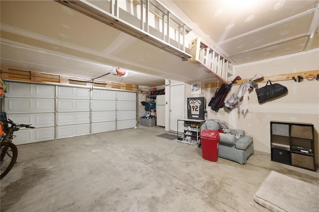 garage featuring a garage door opener and white refrigerator