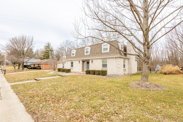 new england style home with a front lawn