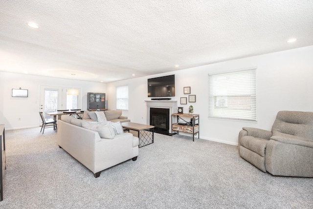 living room with light carpet and a textured ceiling