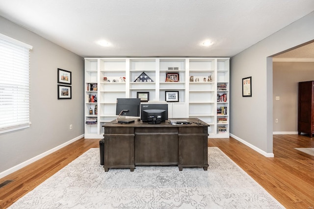 office area with plenty of natural light and light hardwood / wood-style floors