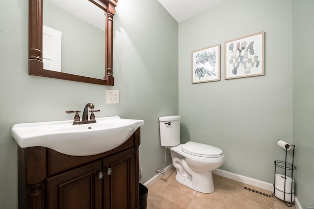 bathroom featuring vanity, tile patterned floors, and toilet