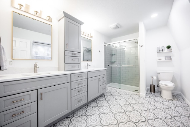 bathroom featuring vanity, toilet, and a shower with shower door