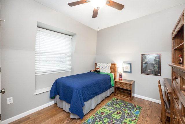 bedroom featuring hardwood / wood-style flooring and ceiling fan