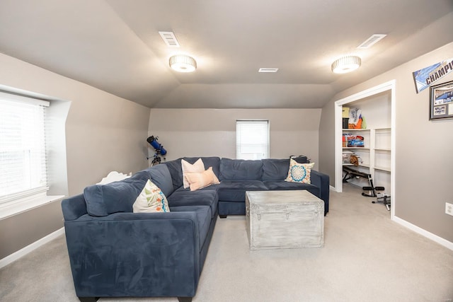 carpeted living room with lofted ceiling