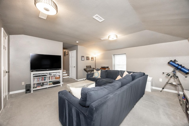 living room featuring vaulted ceiling, carpet, and a textured ceiling