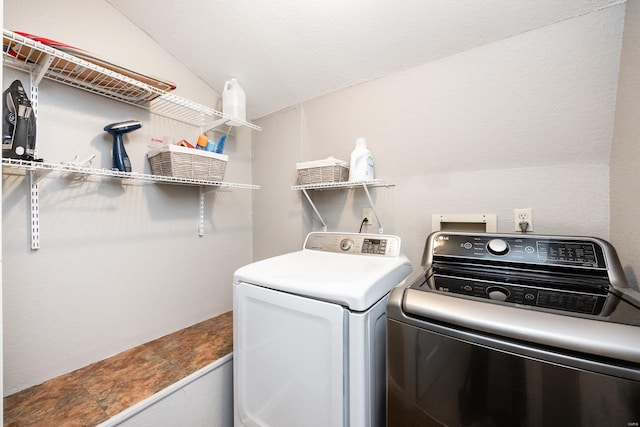 clothes washing area featuring separate washer and dryer