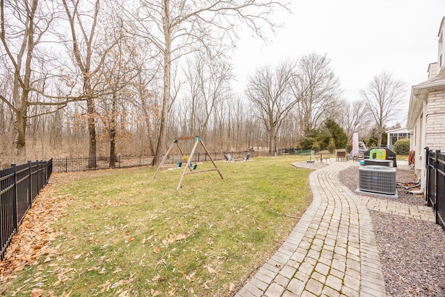 view of yard featuring a playground and central air condition unit