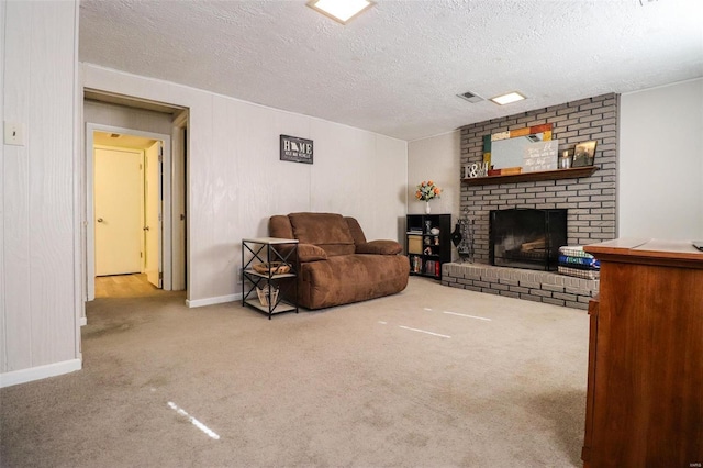 living room featuring a fireplace, carpet floors, and a textured ceiling