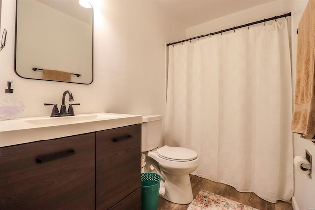 bathroom with vanity, hardwood / wood-style floors, and toilet