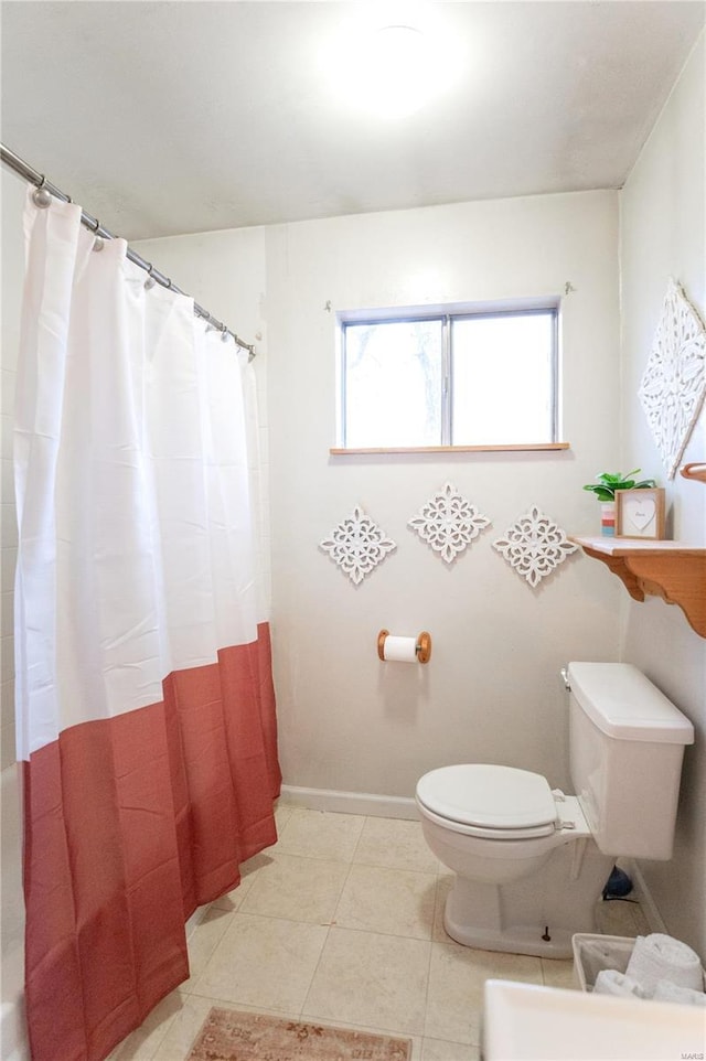 bathroom featuring tile patterned floors, toilet, and a shower with shower curtain