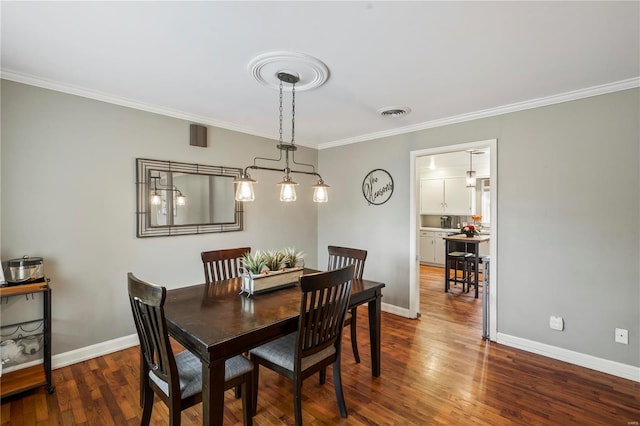 dining space with ornamental molding and dark hardwood / wood-style flooring