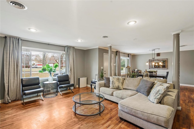 living room with hardwood / wood-style floors and decorative columns