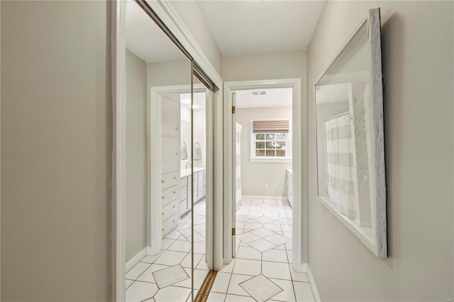 hall featuring light tile patterned floors