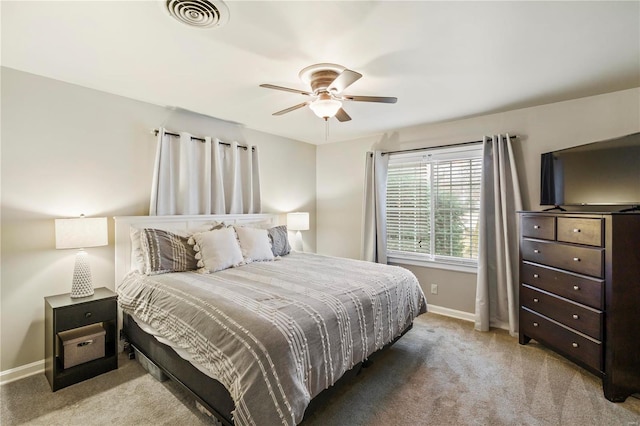 bedroom with ceiling fan and light colored carpet