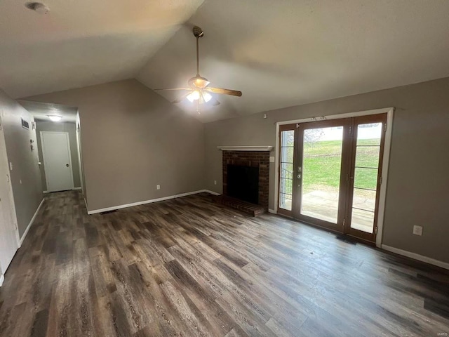 unfurnished living room featuring dark hardwood / wood-style flooring, a fireplace, vaulted ceiling, and ceiling fan